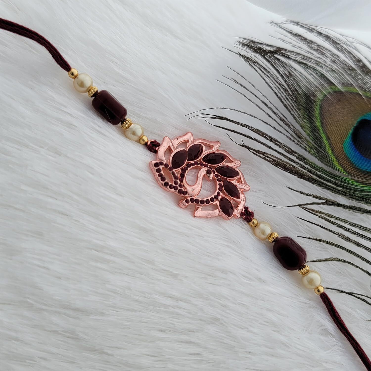Mahi Rose Gold Plated Peacock Shaped Rakhi With Maroon Crystals For Bhai/Brother (Ra1100719Zmar)