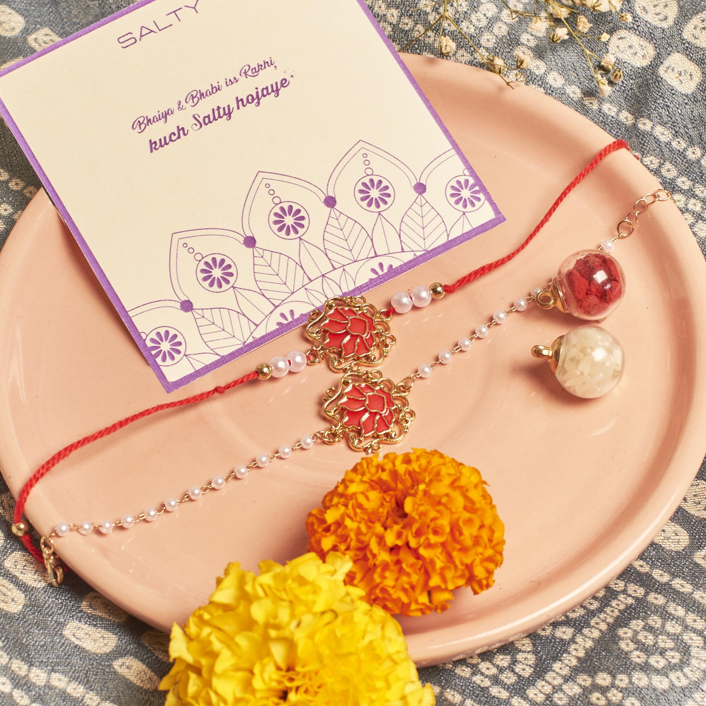 Salty Ruby Lotus Designer Rakhi Set For Bhaiya Bhabhi | Stylish Moli Thread With Roli Chawal | Traditional Lumba Gift For Brother Sister-In-Law | Raksha Bandhan Symbol Of Love & Blessings