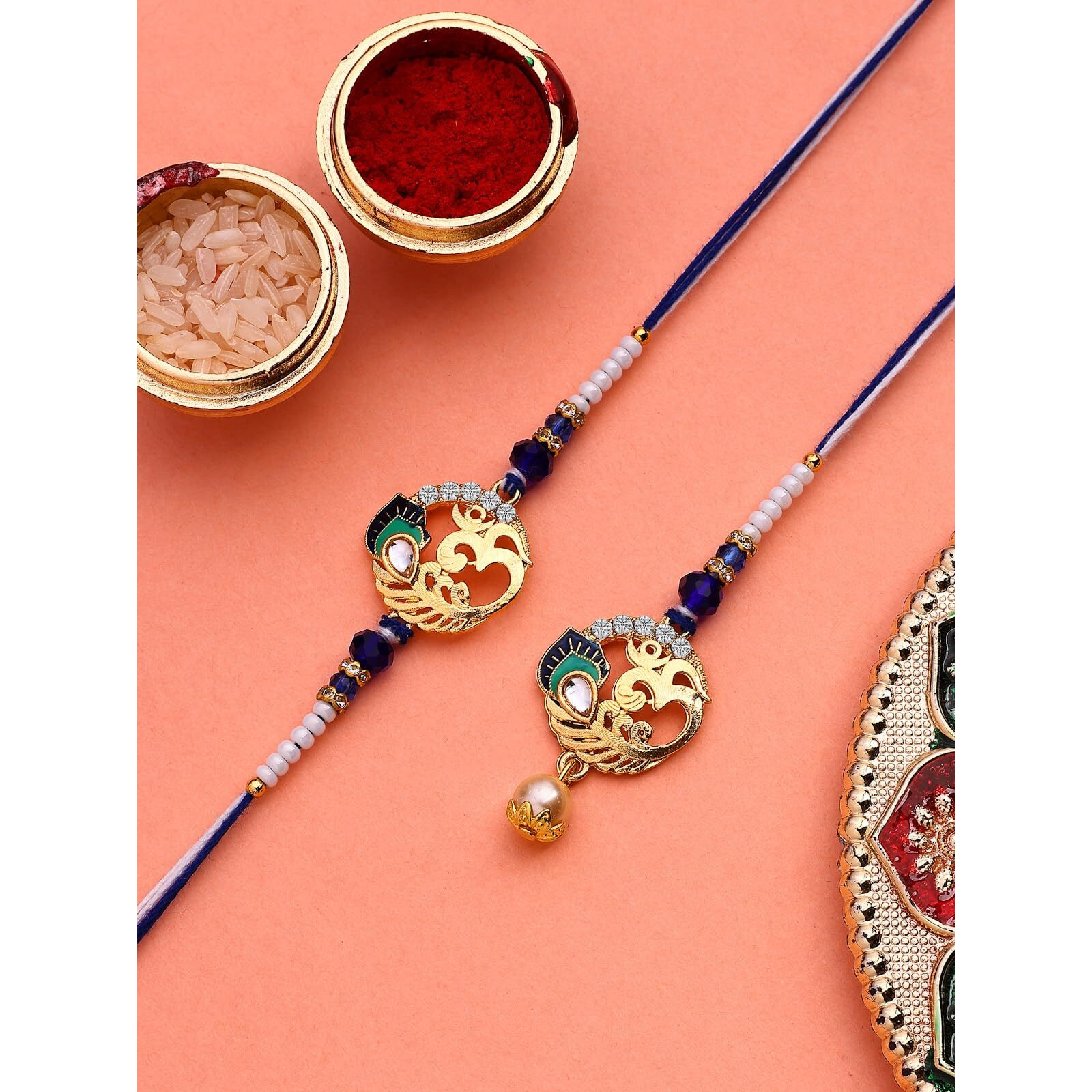Sukkhi Rakhi Creative Gold Plated With Meenakari Handwork Om Rakshabandhan Lumba Rakhi For Brother Bhaiya Bhabhi With Roli Chawal & Greeting Card|Set Of 2|Cbrakl107454