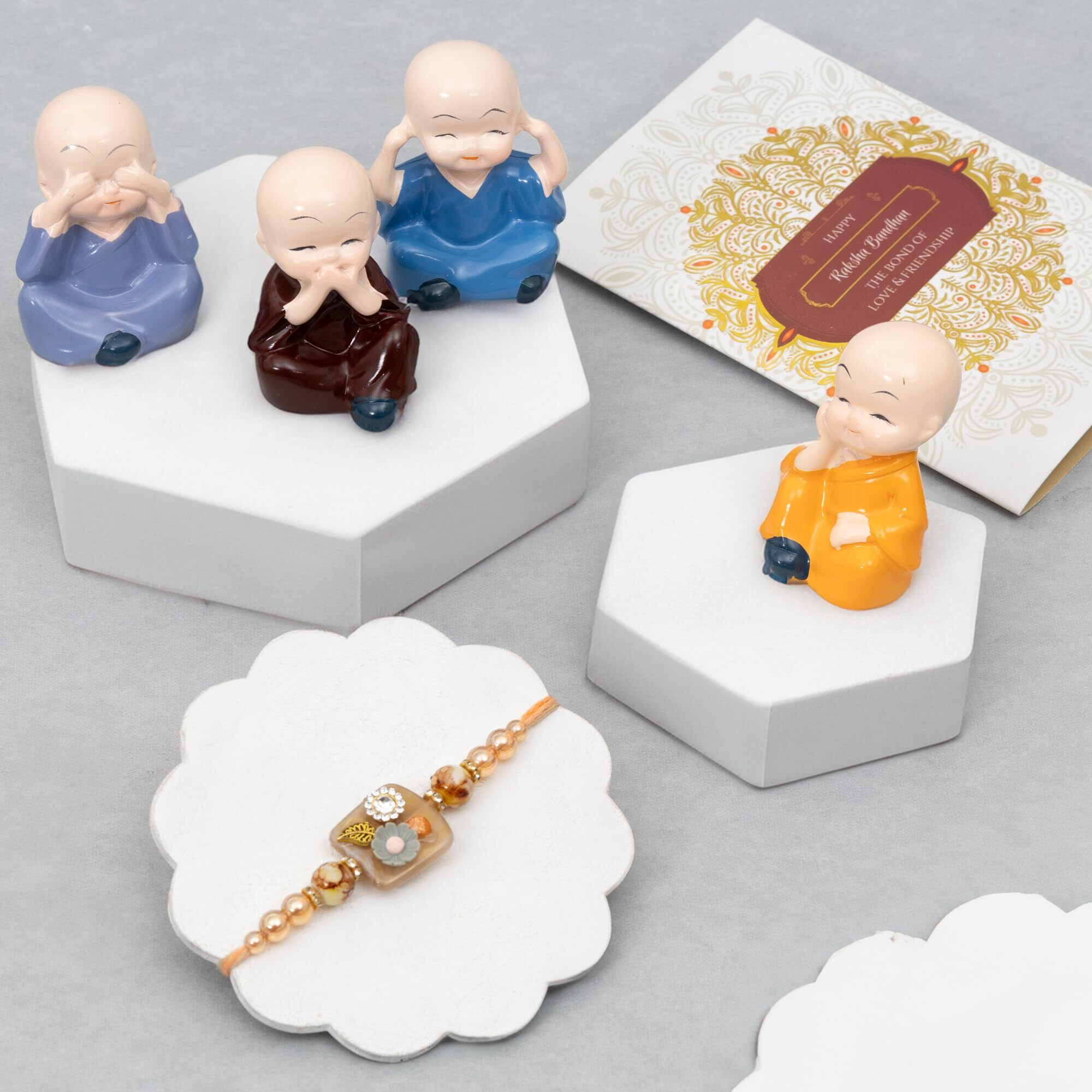 To The Nines Elegant Rakhi With Gift Set For Brother [Gift Combo - Rakhi With Cute Polynesin Monk Set Of 4, Tilak Material & Greeting Card]