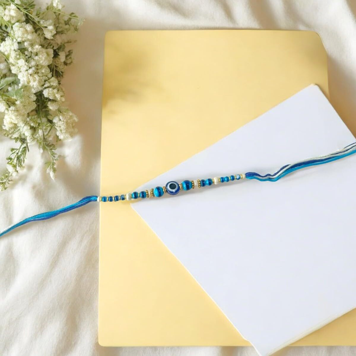 Accessher Quirky Delicate Evil Eye Blue Rakhi For Beloved Brother, Kids & Gifting With Roli Kumkum Packets & Happy Rakshabandhan Card (Pack Of 1)