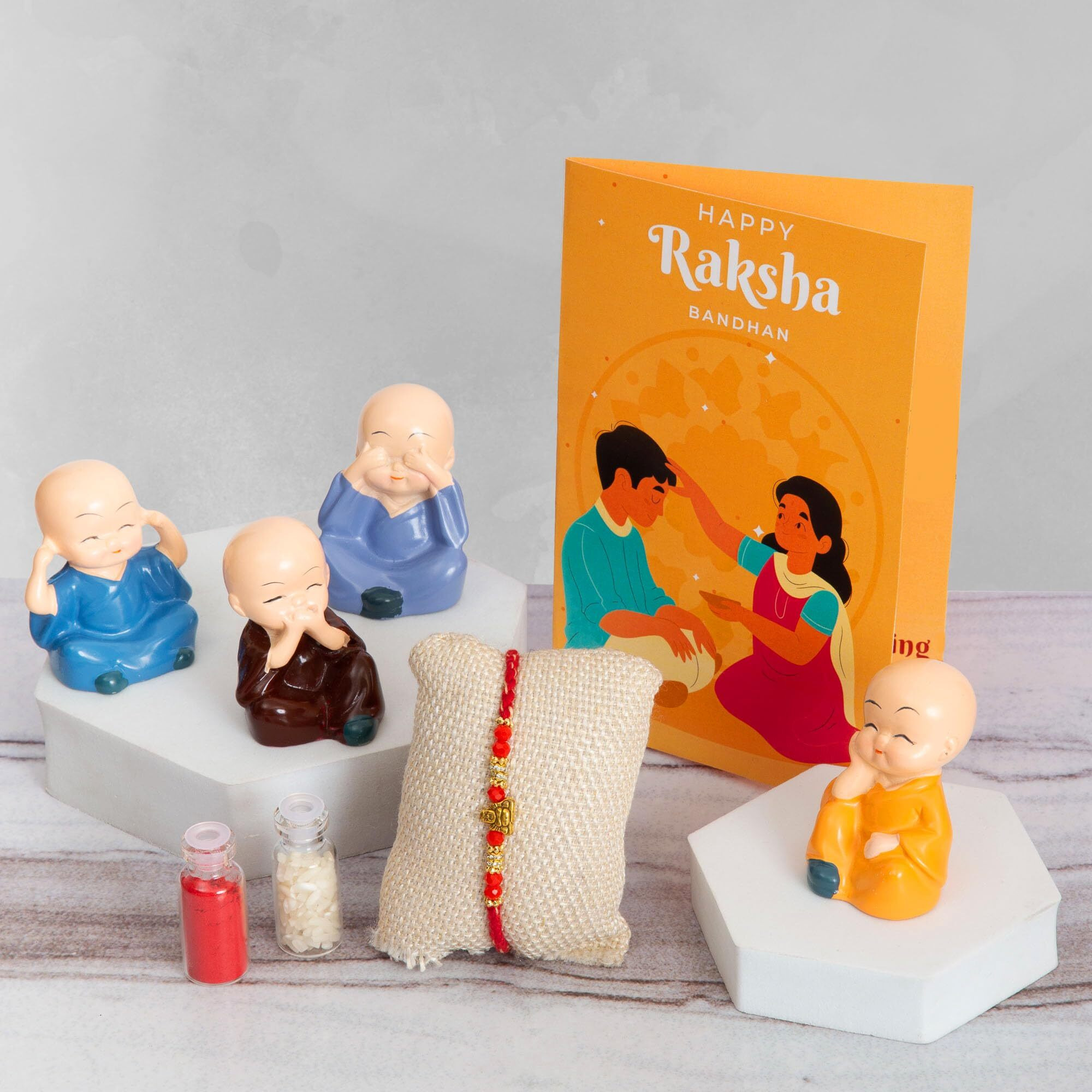 To The Nines Rakhi Gift Set For Brother Gift Combo - Rakhi With Polyresin Buddha Set Of 4, Tilak Material And Greeting Card