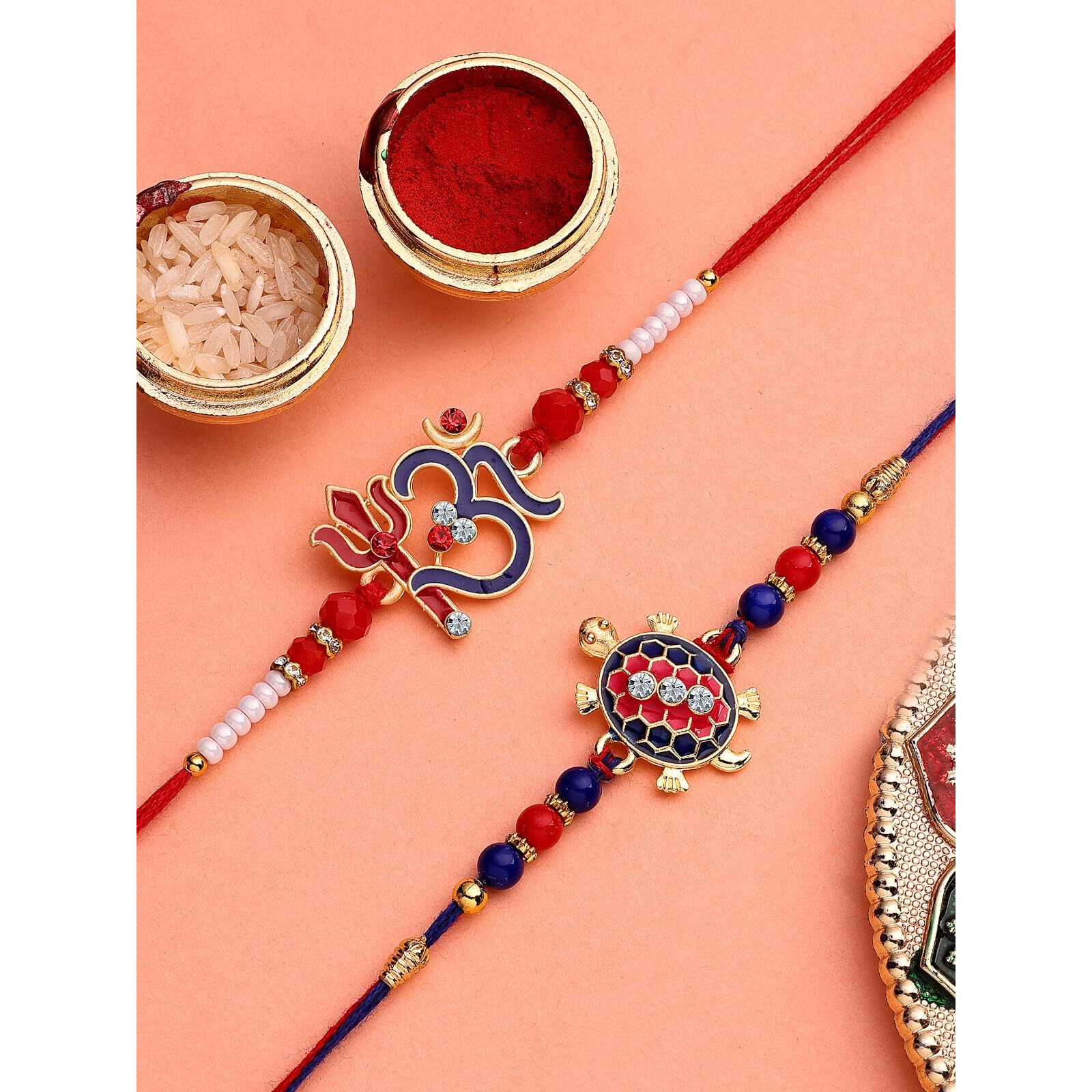 Sukkhi Rakhi Om Trishul & Tortoise Designer Gold Plated With Ad Stones & Meenakari Hand Work Combo Rakhi For Brother With Roli Chawal & Greeting Card|Set Of 2|Cbrak107442