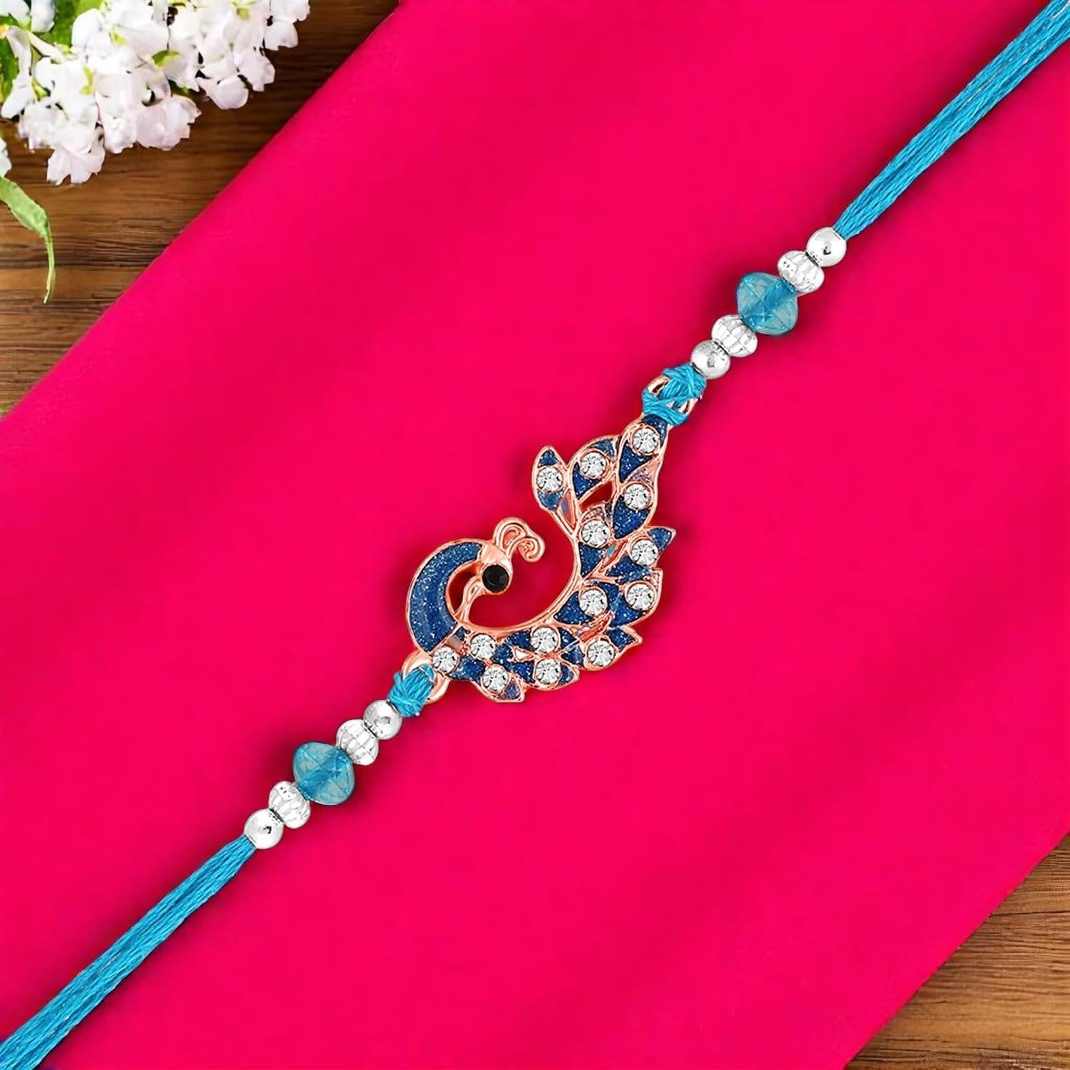 Mahi Rose Gold Plated Blue Glossy Meenakari Work Peacock-Shaped Fancy Rakhi With Crystals For Brother, Bhai, Bro (Ra1100762Z)