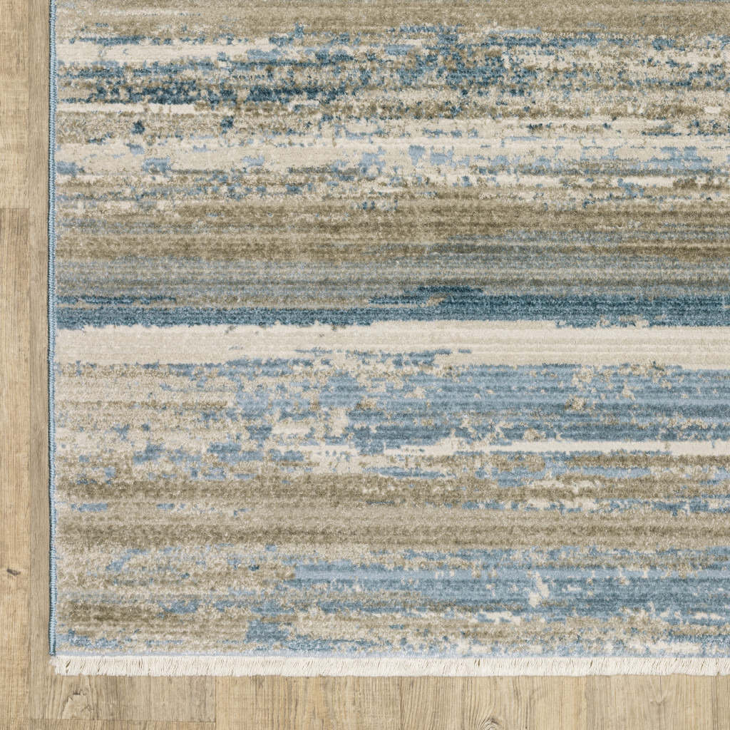 5 X 8 Ivory Beige grey Blue And Tan Abstract Power Loom Stain Resistant Area Rug With Fringe