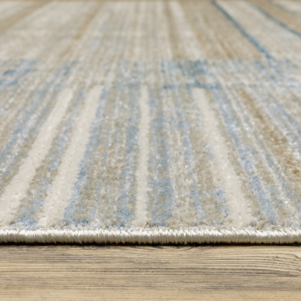 5 X 8 Blue Dark Blue Teal grey Ivory Beige And Tan geometric Power Loom Stain Resistant Area Rug With Fringe