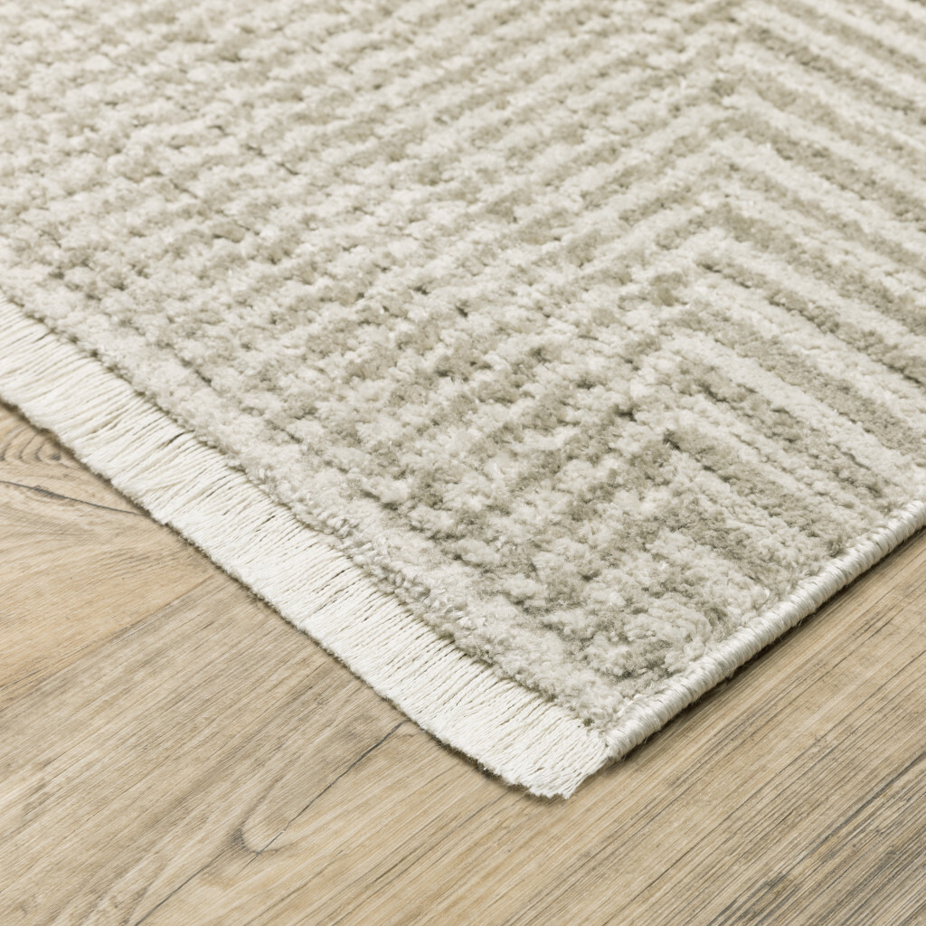 5 X 8 Ivory Beige Taupe And Tan geometric Power Loom Stain Resistant Area Rug With Fringe