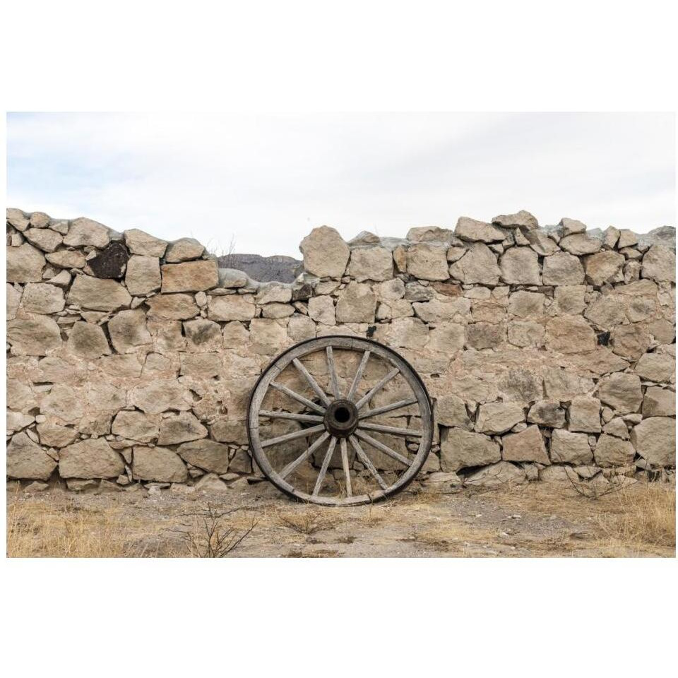 Wagon wheel against a stone fence at Hueco Tanks State Park, northwest of El Paso, TX-Paper Art-20&quotx14"