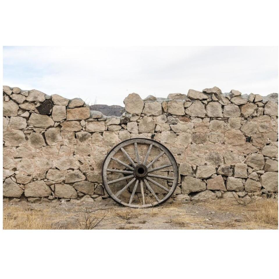 Wagon wheel against a stone fence at Hueco Tanks State Park, northwest of El Paso, TX-Paper Art-38&quotx26"