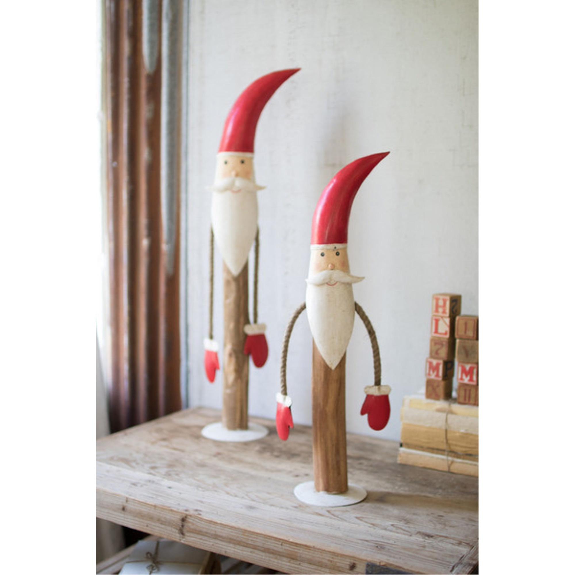 SET OF TWO PAINTED METAL AND WOOD SANTAS