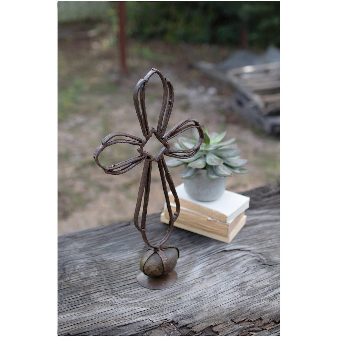 RECYCLED METAL SISTER CLARAS CROSS ON A CAGED ROCK BASE