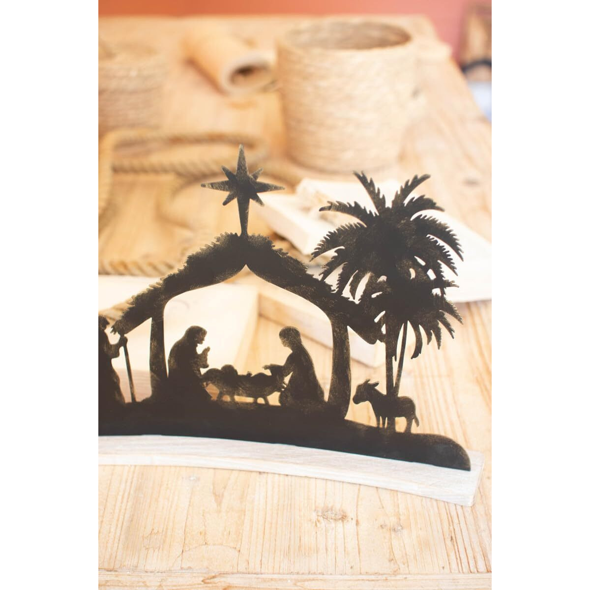 BLACK METAL NATIVITY ON A CURVED WHITE WOOD BASE