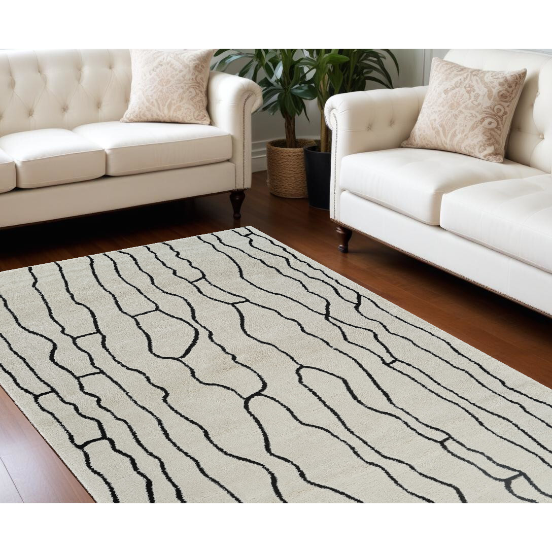 8' X 11' Cream and Black Abstract Distressed Area Rug