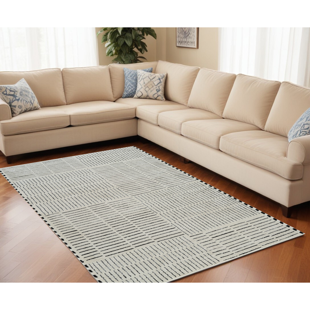 5' X 8' Cream and Black Abstract Distressed Area Rug