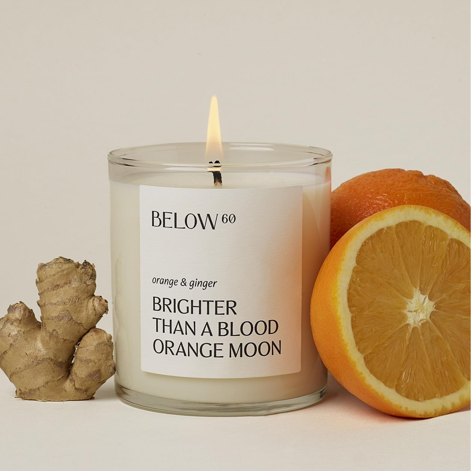 Below 60 Scented Candle - Brighter Than A Blood Orange Moon - Essential Oil-Based - Hand-Made With Paraffin-Free Soy Wax - 100% Cotton Wick - 50 Hr Burn Time - By Hilary Duff - Orange & Ginger (10Oz)