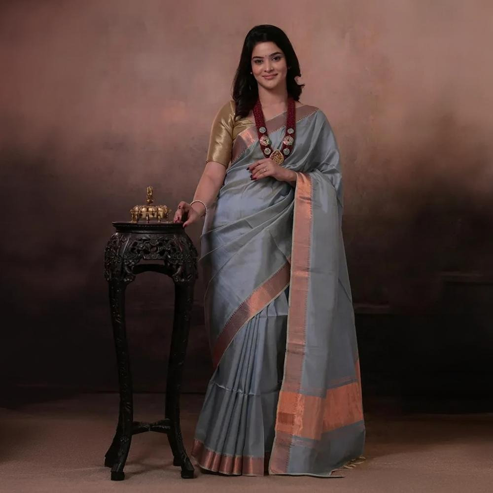 Bhadra - Powder Blue Plain Handwoven Silk Saree With Copper Zari Border