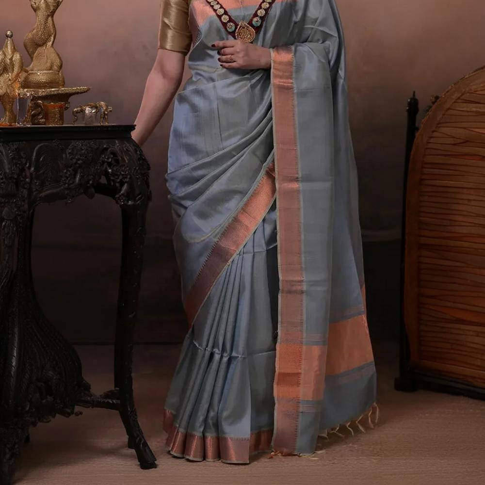 Bhadra - Powder Blue Plain Handwoven Silk Saree With Copper Zari Border